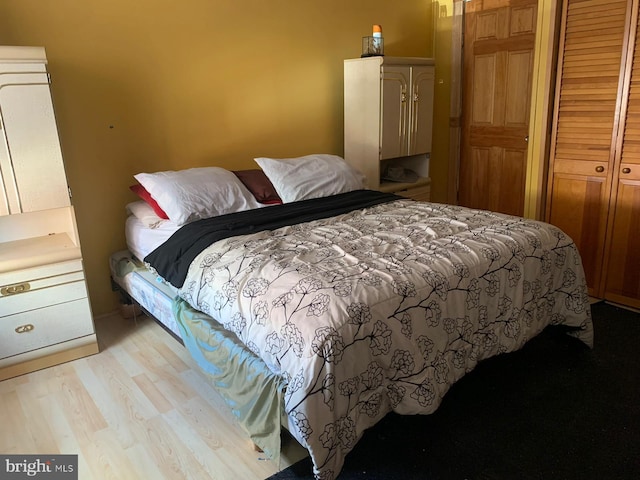 bedroom featuring a closet and light hardwood / wood-style floors