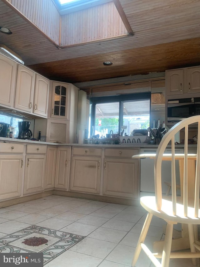 kitchen featuring wooden ceiling and light tile floors