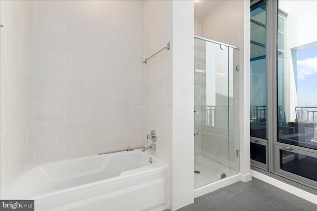 bathroom featuring independent shower and bath and tile floors