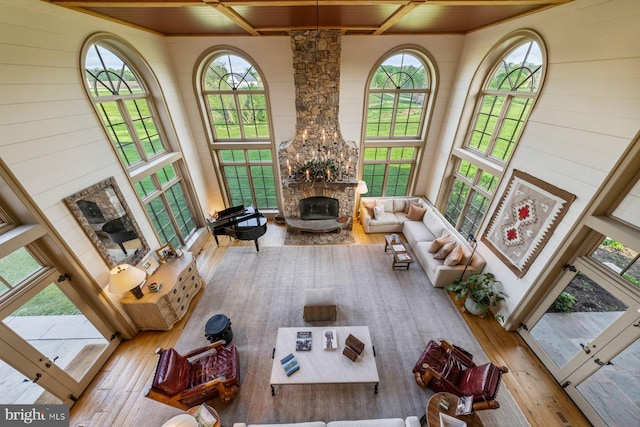 living room featuring light wood-type flooring, wood ceiling, and a fireplace