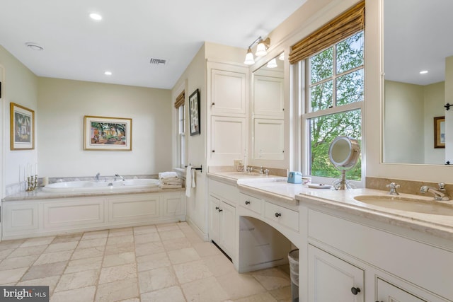 bathroom with vanity and a tub to relax in