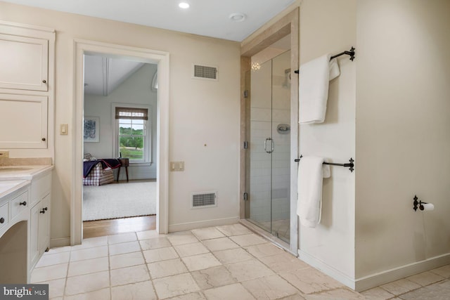 bathroom featuring vanity and a shower with shower door