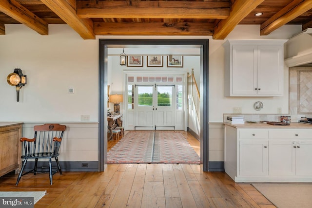 kitchen featuring white cabinets, light hardwood / wood-style floors, wood ceiling, and beamed ceiling