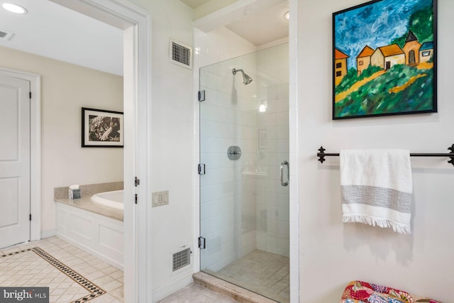 bathroom with tile patterned floors and independent shower and bath