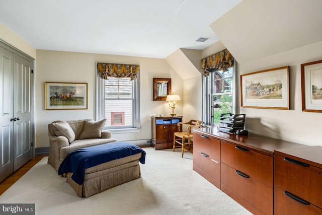 sitting room featuring light carpet and a healthy amount of sunlight