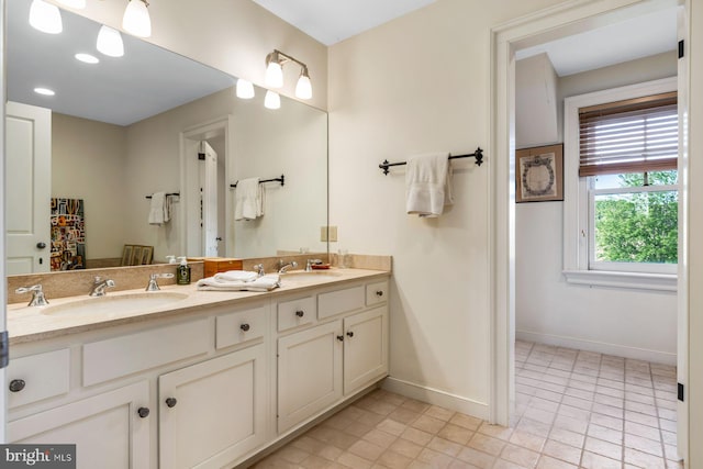 bathroom featuring tile patterned flooring and vanity