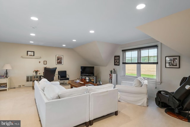 carpeted living room featuring lofted ceiling