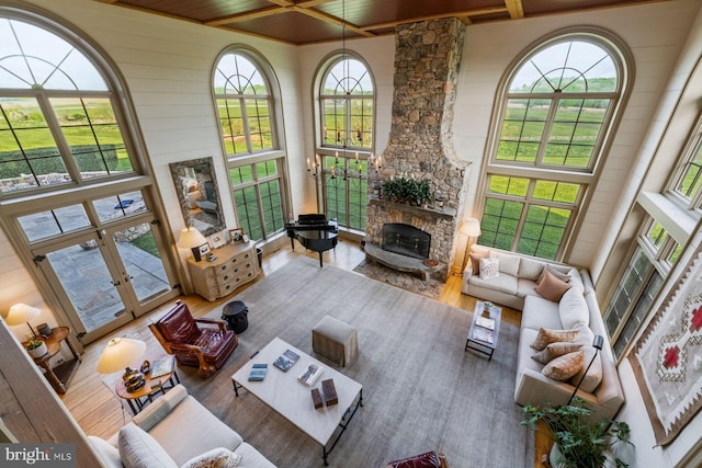 sunroom / solarium with a fireplace, french doors, and wooden ceiling