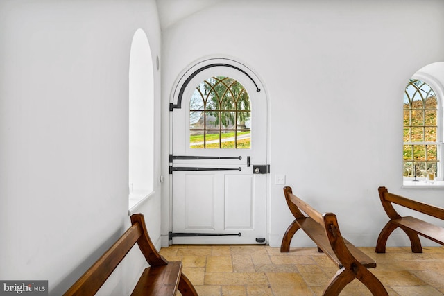 doorway to outside with tile flooring and a healthy amount of sunlight