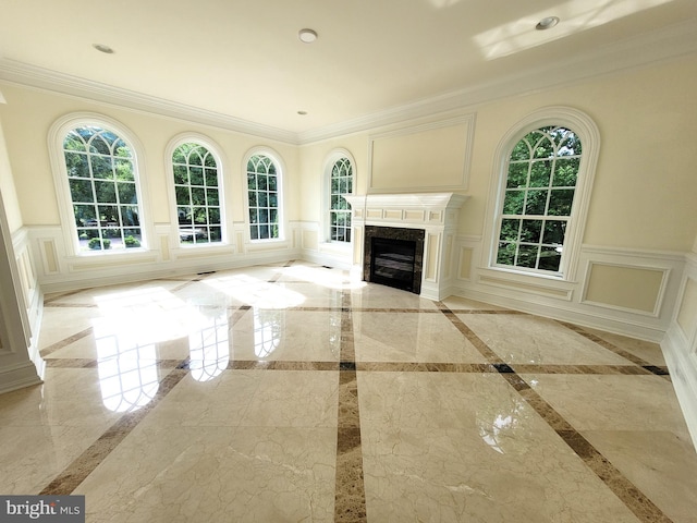 unfurnished living room with crown molding and a premium fireplace