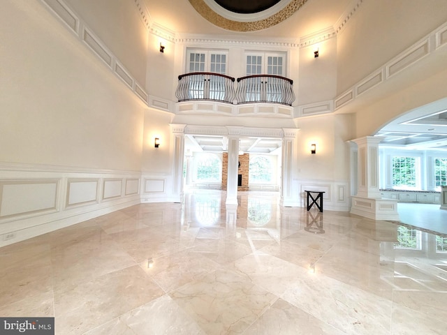 interior space featuring ornate columns and a towering ceiling