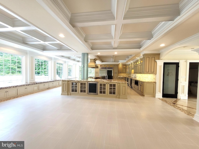 unfurnished living room with beamed ceiling, coffered ceiling, and ornamental molding