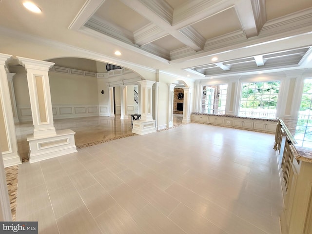 unfurnished living room featuring ornate columns, crown molding, beamed ceiling, and coffered ceiling