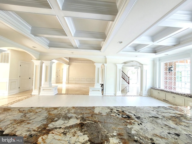 unfurnished room with coffered ceiling, crown molding, and decorative columns