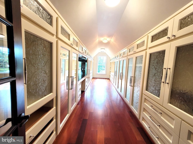 corridor featuring dark hardwood / wood-style flooring, french doors, and lofted ceiling