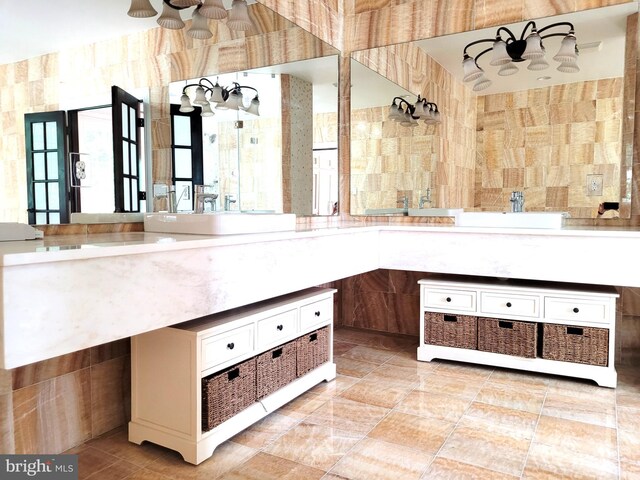 bathroom featuring vanity and tile walls