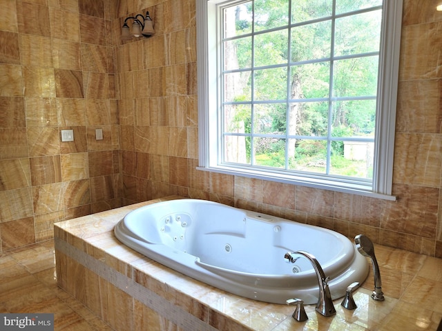 bathroom with tiled bath and plenty of natural light