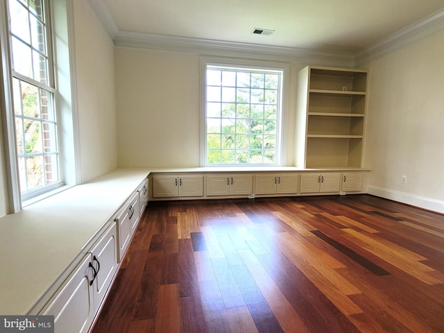 interior space with dark hardwood / wood-style flooring and ornamental molding