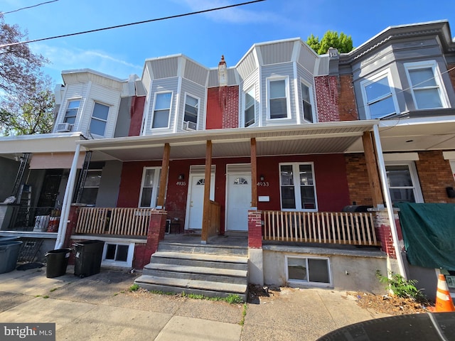 townhome / multi-family property with a porch