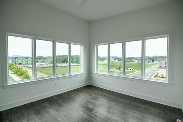 spare room with dark hardwood / wood-style flooring