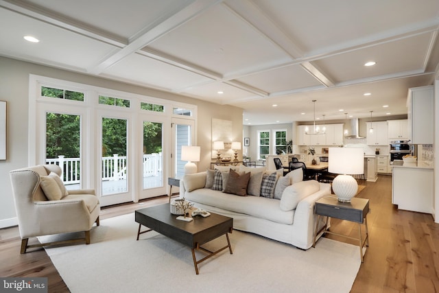 living room featuring light hardwood / wood-style flooring, a wealth of natural light, and coffered ceiling