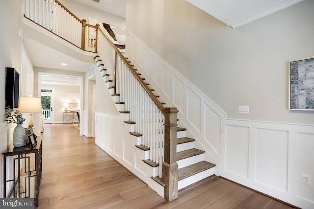 staircase with light hardwood / wood-style floors