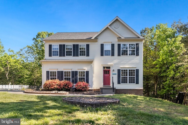 colonial home featuring a front lawn