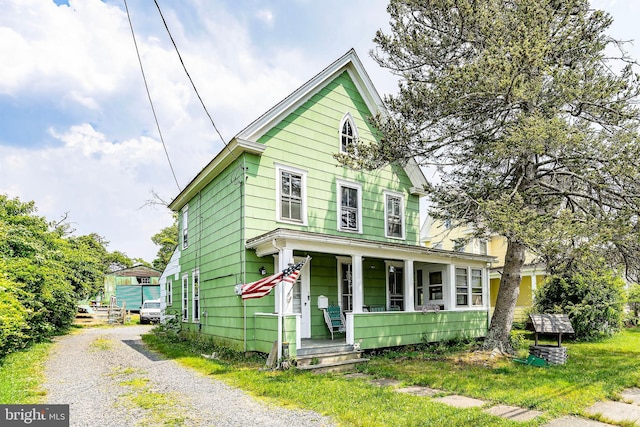 view of front of house with a porch and central AC unit