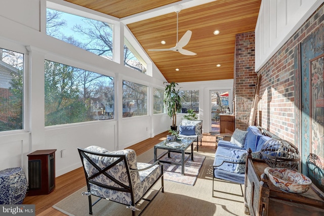 sunroom featuring lofted ceiling, ceiling fan, and wood ceiling