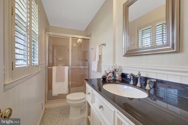 bathroom featuring wainscoting, vanity, and toilet