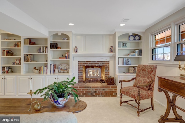 living area featuring built in shelves, a fireplace, recessed lighting, visible vents, and carpet flooring