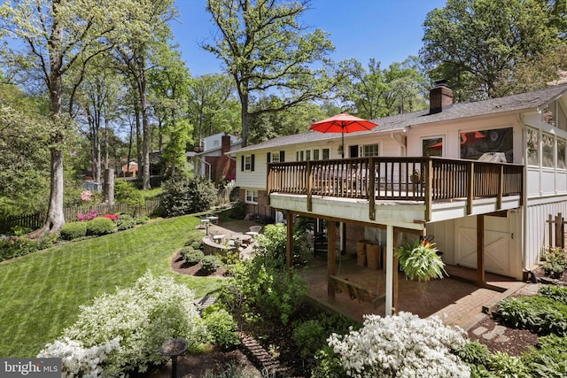 exterior space featuring a patio, a wooden deck, and fence