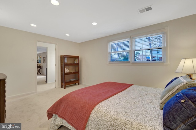 bedroom with light carpet, recessed lighting, visible vents, and baseboards