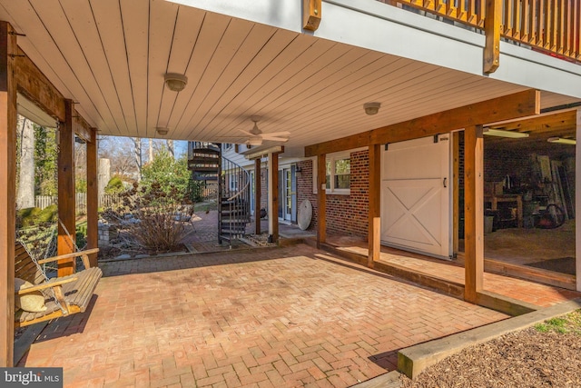 view of patio featuring ceiling fan and stairway