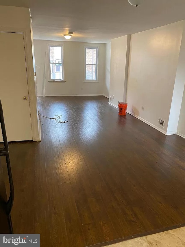 spare room with dark hardwood / wood-style floors