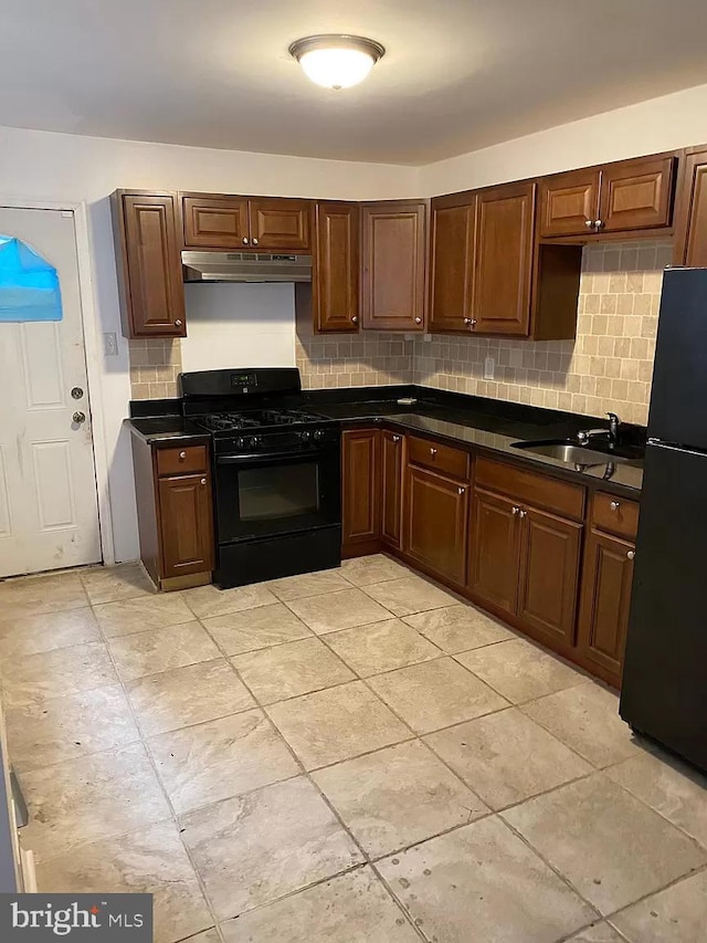 kitchen featuring sink, backsplash, light tile floors, and black appliances