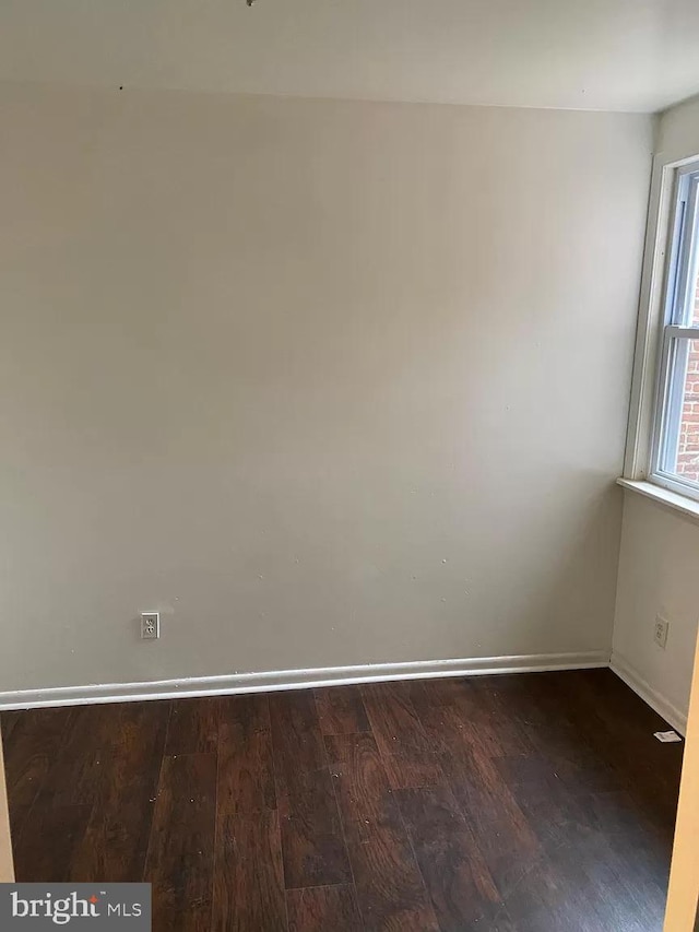 spare room featuring wood-type flooring