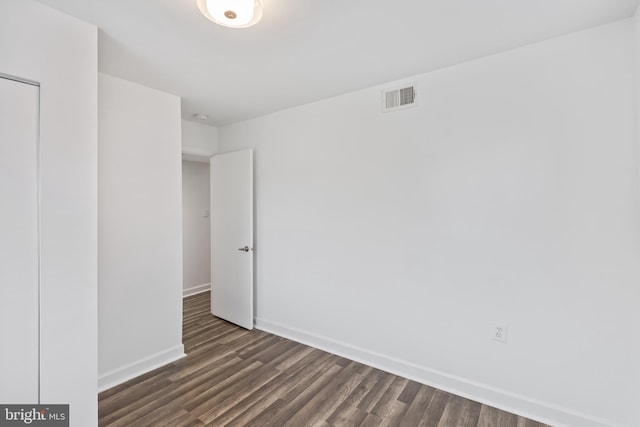 unfurnished room with dark hardwood / wood-style flooring