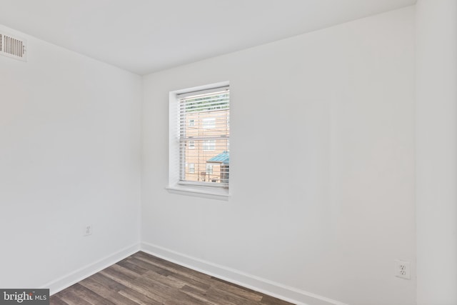 unfurnished room with dark hardwood / wood-style floors