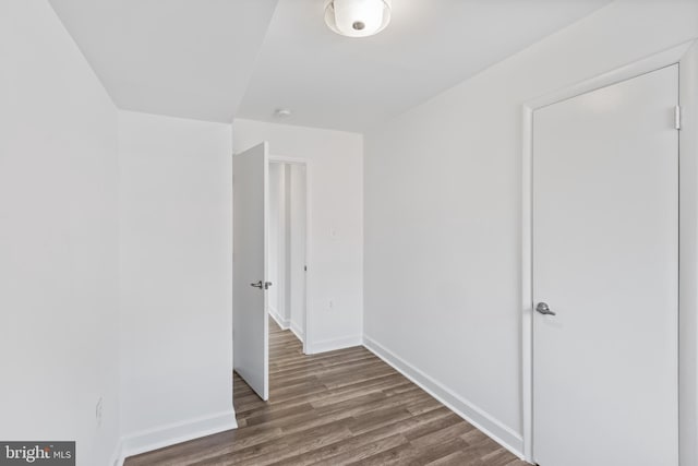 unfurnished room featuring dark wood-type flooring