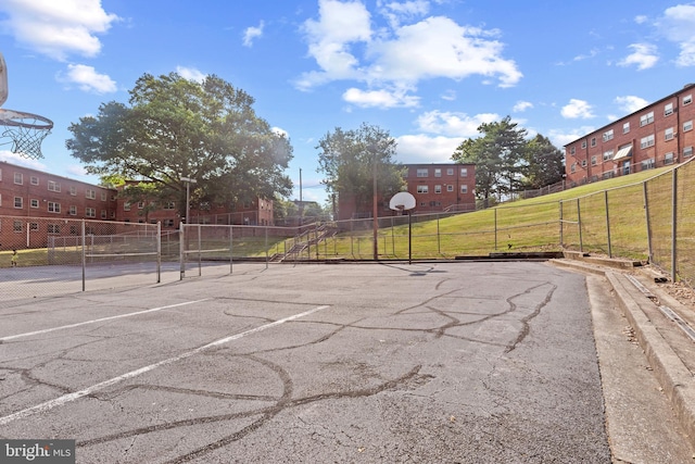 view of sport court with a lawn