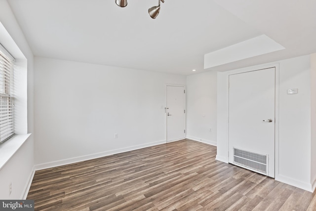 spare room with wood-type flooring