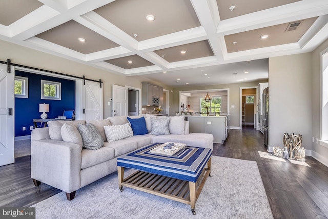 living room with beamed ceiling, a barn door, coffered ceiling, sink, and dark hardwood / wood-style floors