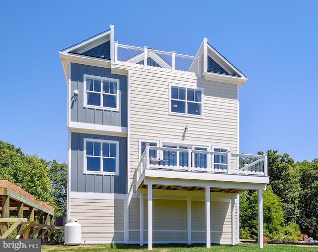 back of property featuring a deck and central air condition unit