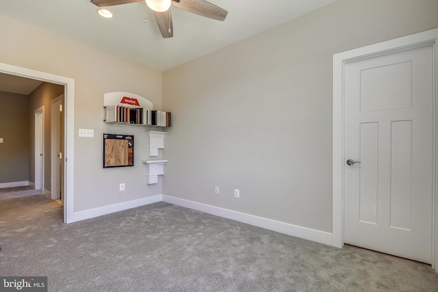 unfurnished living room with ceiling fan and carpet flooring