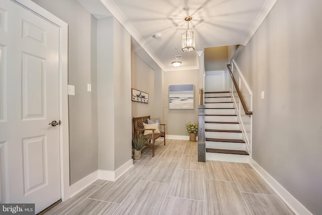 tiled entryway featuring ornamental molding