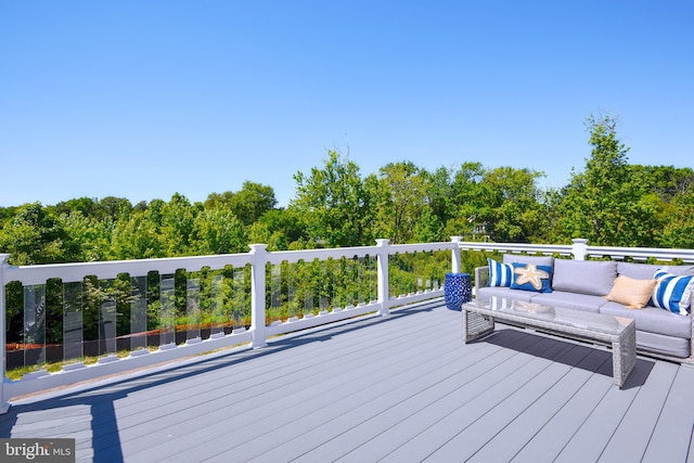 wooden terrace featuring an outdoor living space