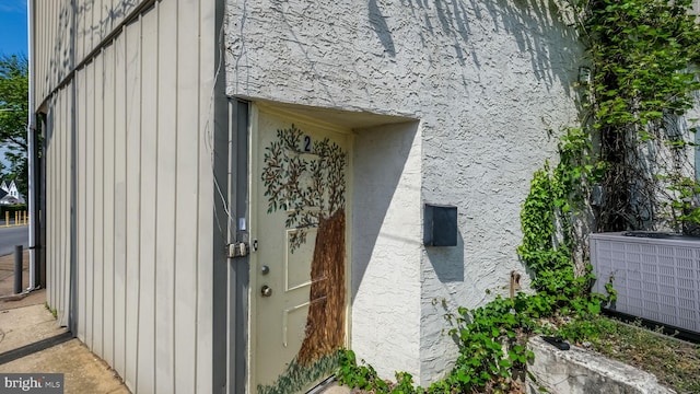 entrance to property featuring central air condition unit