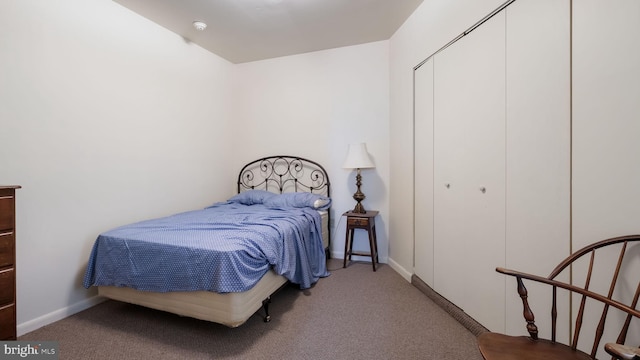 carpeted bedroom with a closet