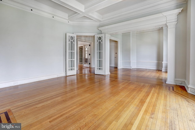 empty room with french doors, crown molding, light hardwood / wood-style flooring, beam ceiling, and coffered ceiling